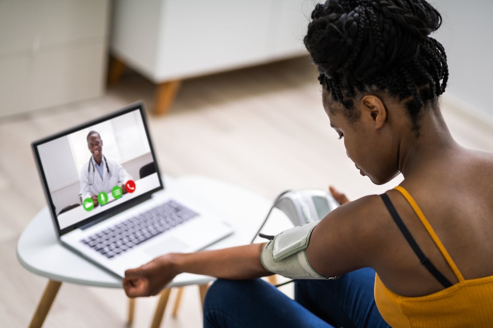 Lady speaking a doctor via her laptop - Telemedicine Telemedicine in Nigeria - Lady Accessing care through the laptop.